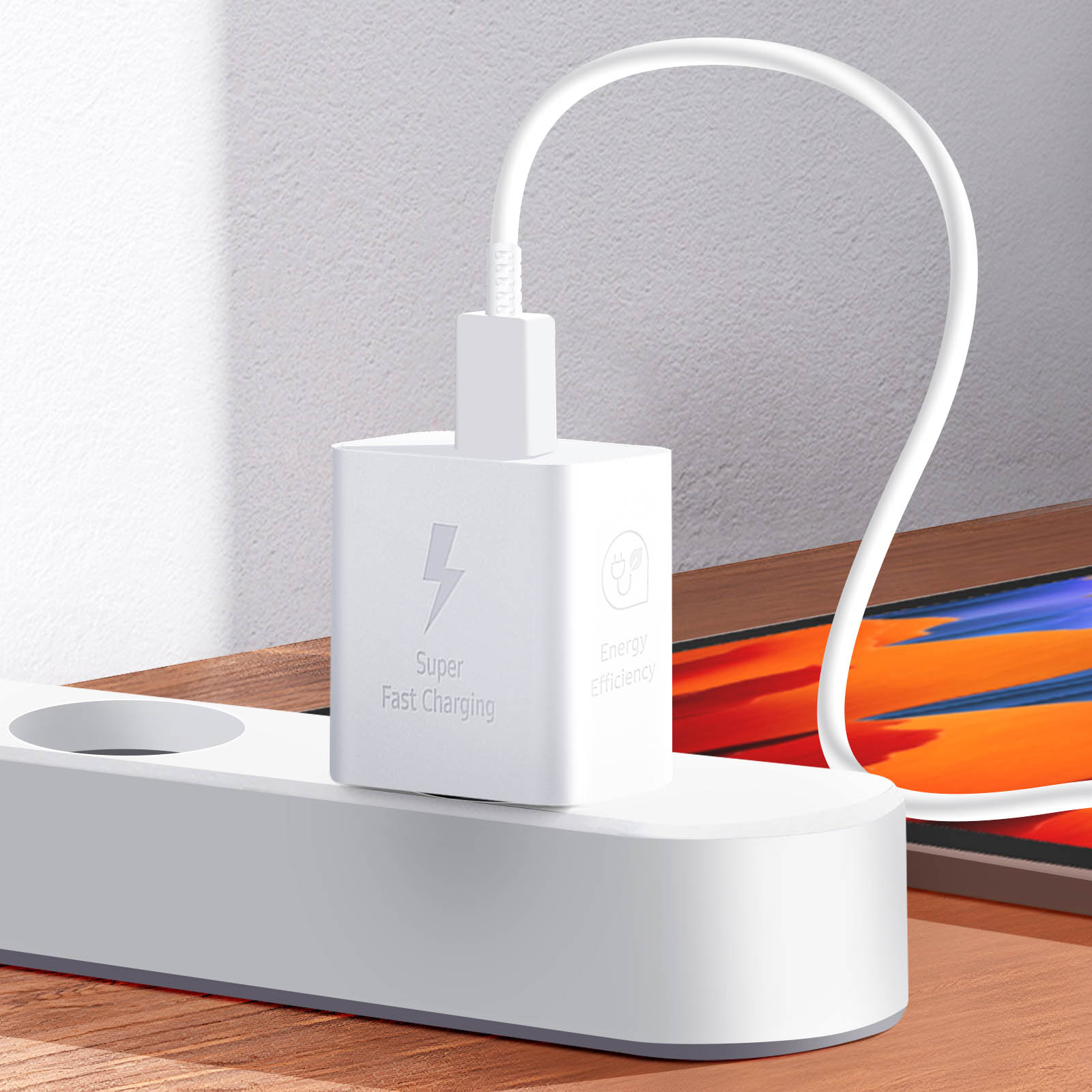 White charger plugged into a power strip. The charger has a lightning bolt symbol.