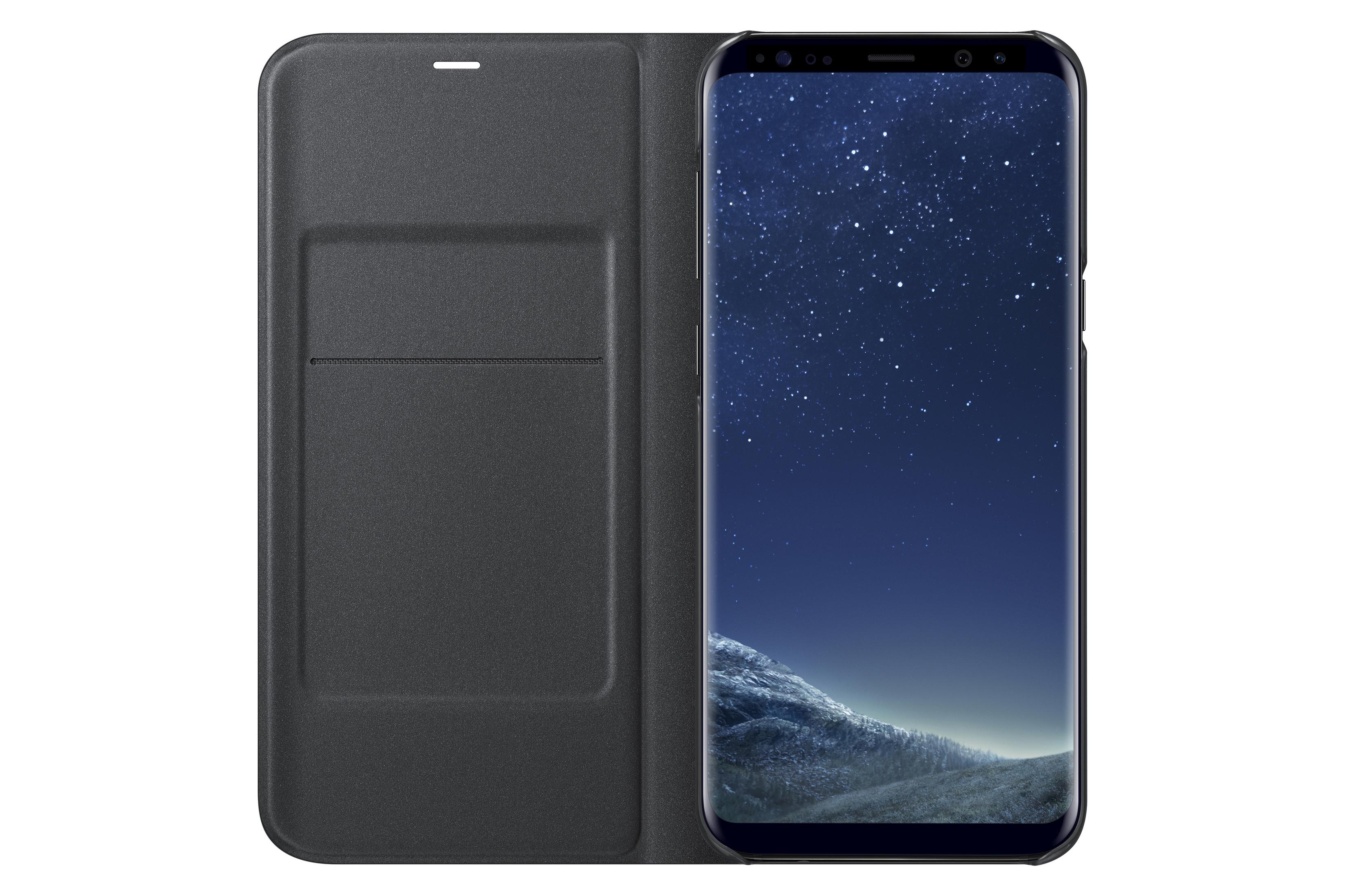 Dunkelgraues Handyhülle im geöffneten Zustand neben einem Smartphone mit Sternenhimmel-Hintergrund.