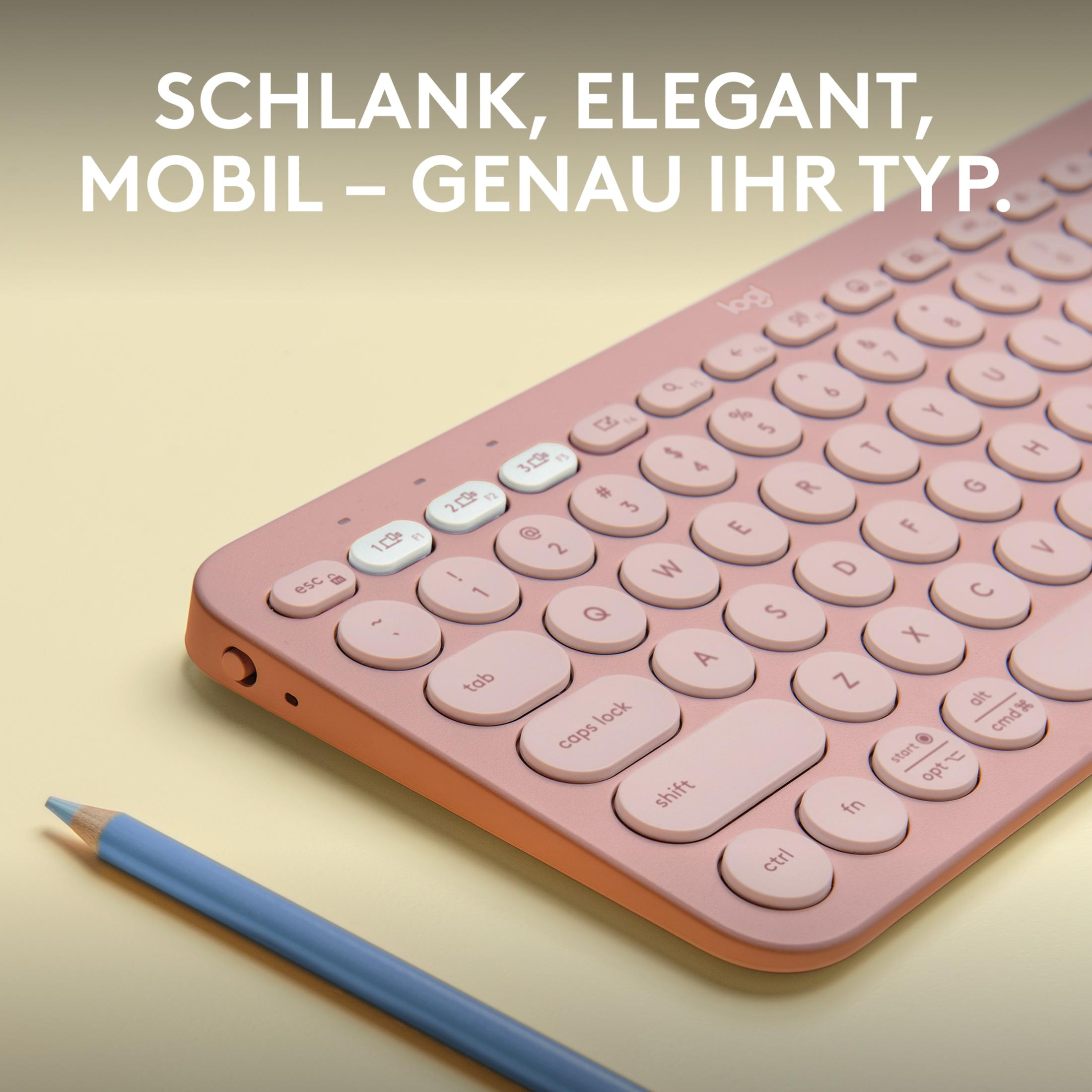 Rosa Tastatur mit weißen Tasten und blauem Bleistift. Text auf der Tastatur ist sichtbar. Die Farbe ist rosa.