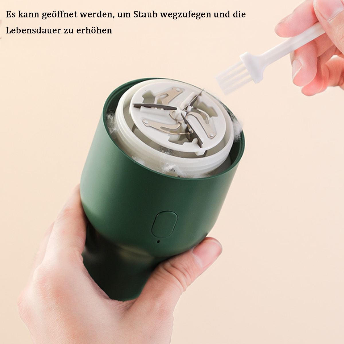 Eine Hand hält eine kleine Reinigungsbürste über einem grünen Gerät.