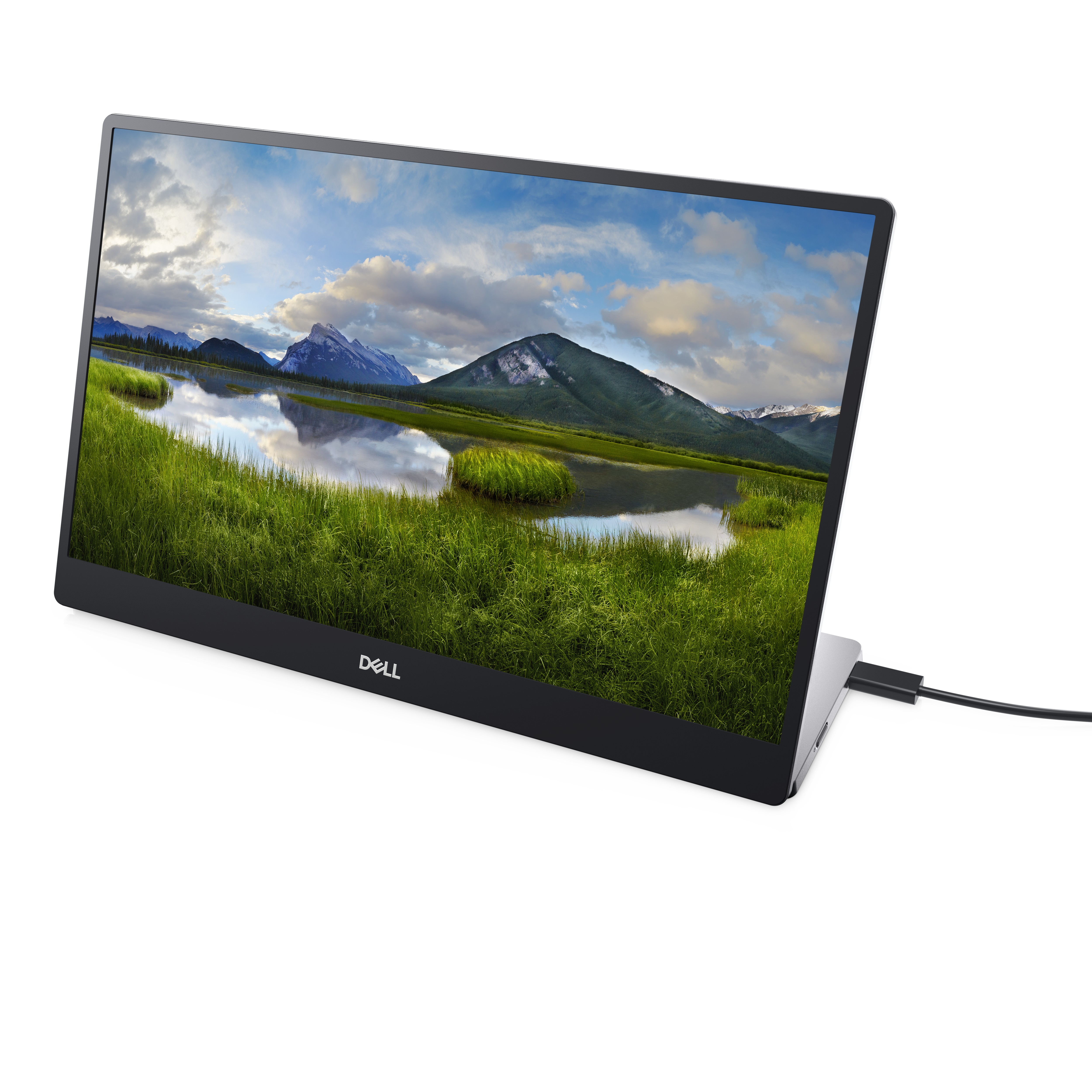 Laptop mostrando un paisaje, en ángulo sobre fondo blanco, con cable conectado.