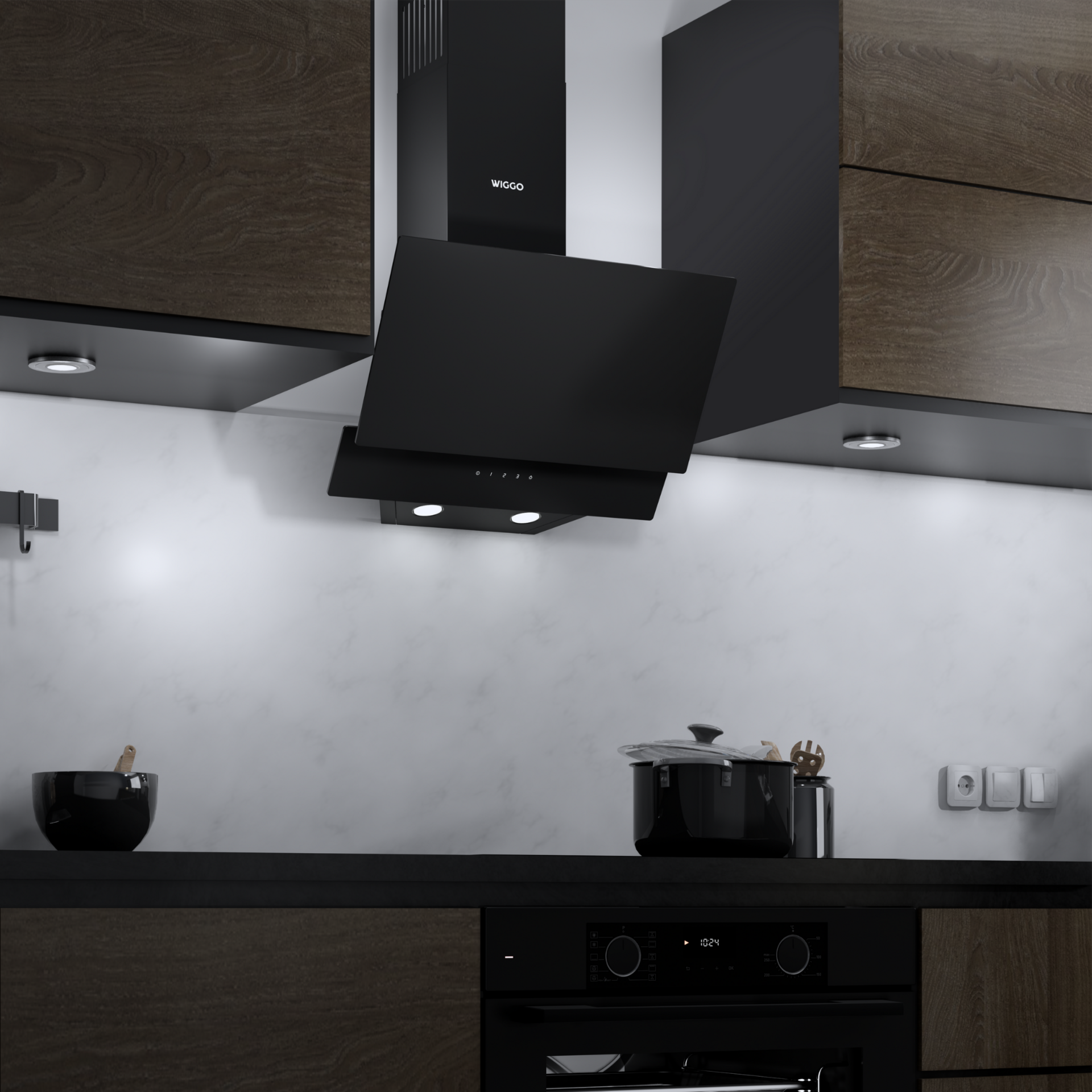 Hotte de cuisine noire installée sur un mur blanc. Une casserole noire et des lumières sont visibles.