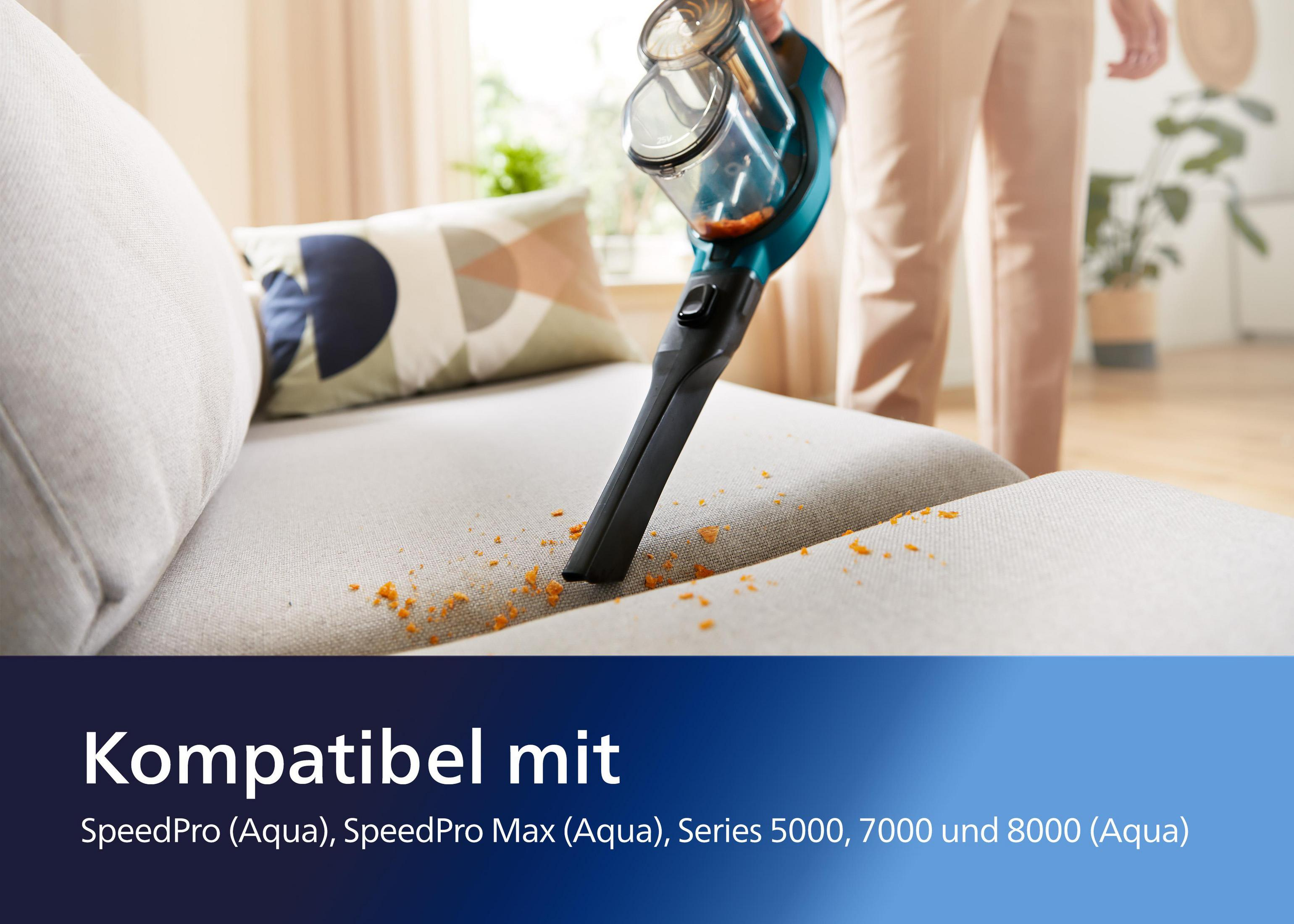 Odkurzacz ręczny czyści sofę. Tekst na dole mówi 'Kompatibel mit'.