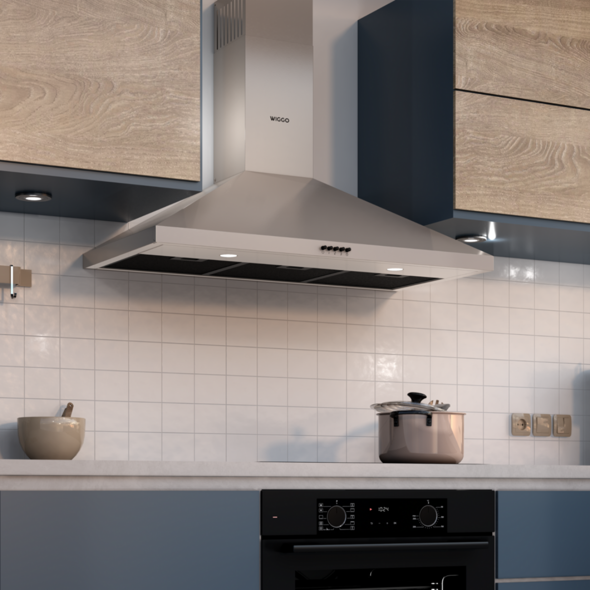 Une hotte en acier inoxydable au-dessus d'une plaque à induction, avec une casserole sur la cuisinière.