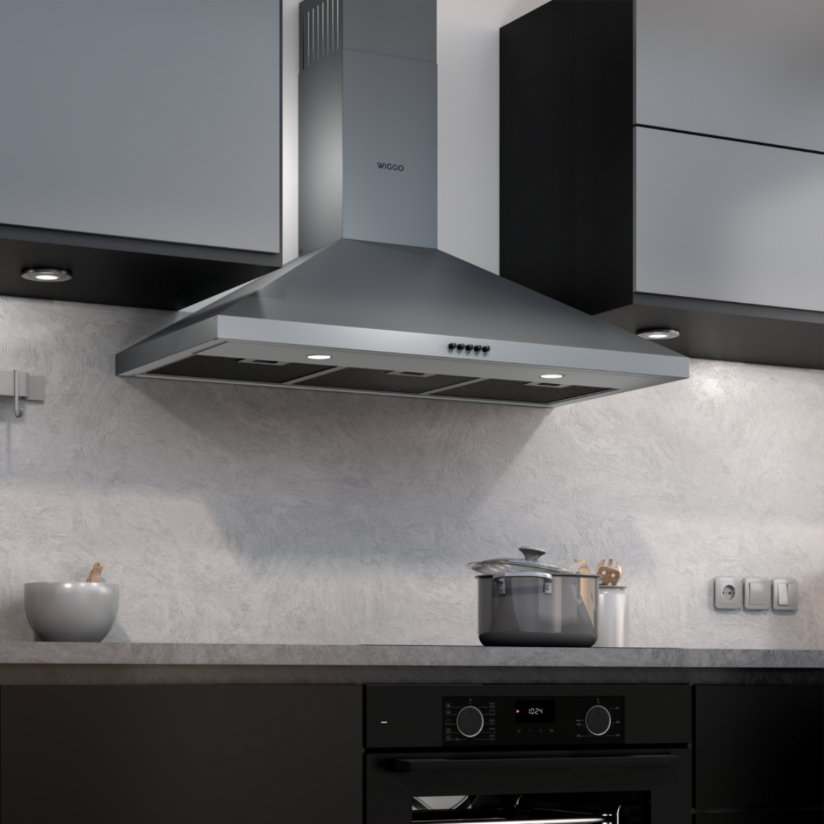 Une hotte en acier inoxydable dans une cuisine, au-dessus d'une cuisinière avec une casserole dessus.