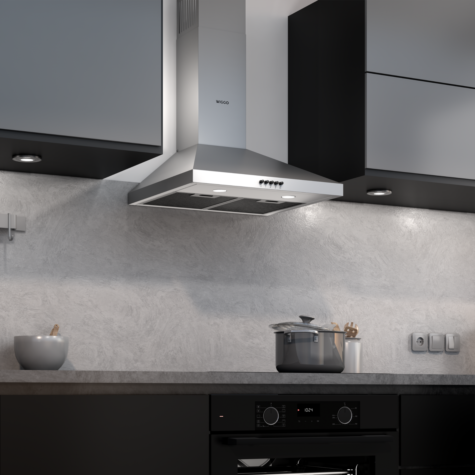 Scène de cuisine avec hotte aspirante en acier inoxydable, meubles noirs, casserole sur le comptoir et mur gris.