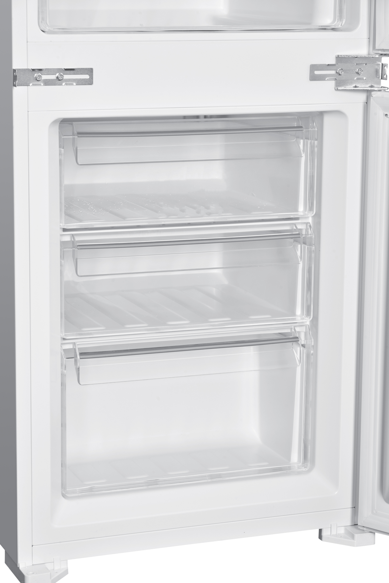 Inside of a white refrigerator with three transparent drawers.