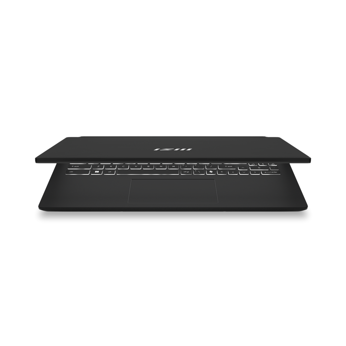 Laptop negro sobre fondo negro, cerrado. Teclado visible.