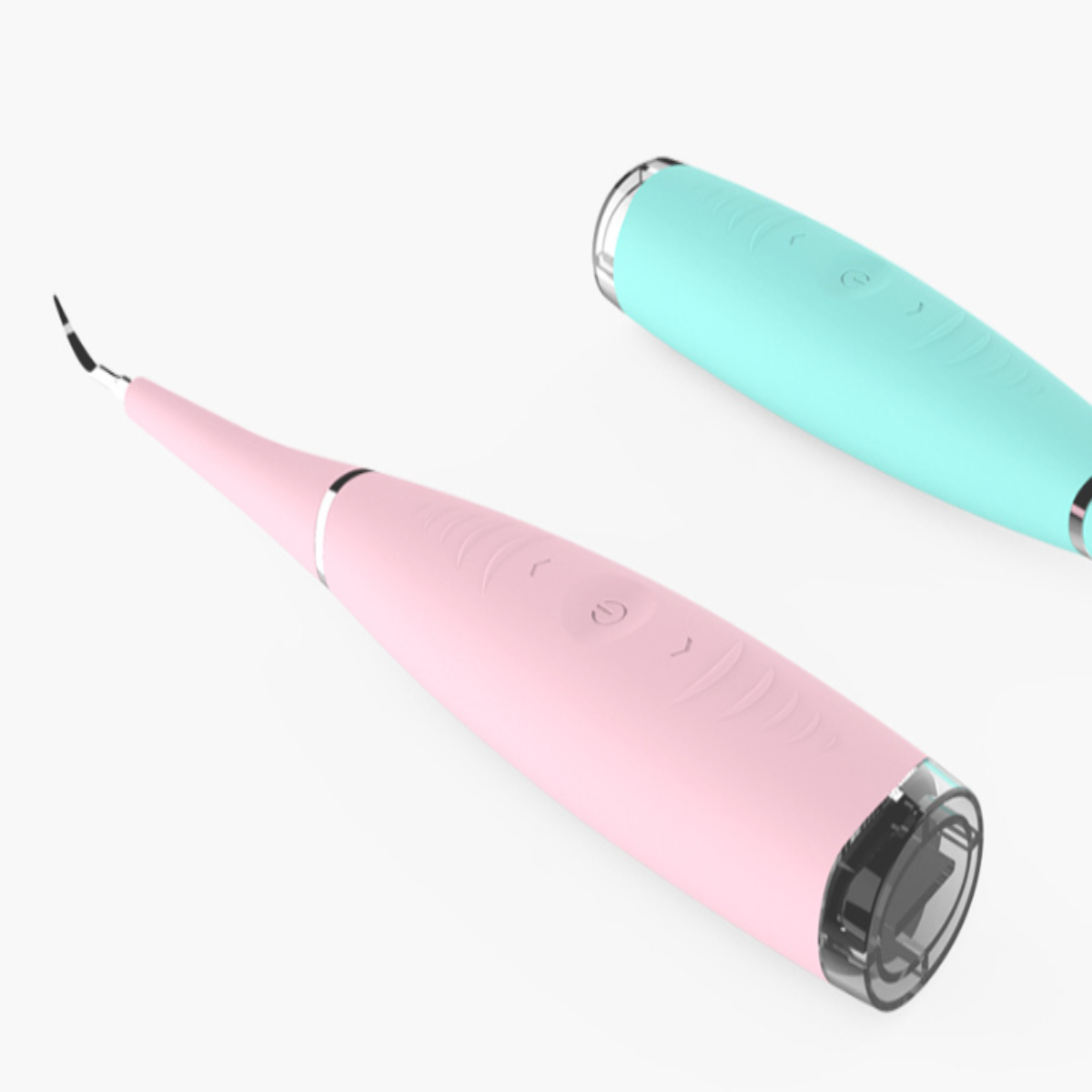 Zwei Dentalwerkzeuge in Rosa und Türkis, die auf einer weißen Oberfläche liegen.