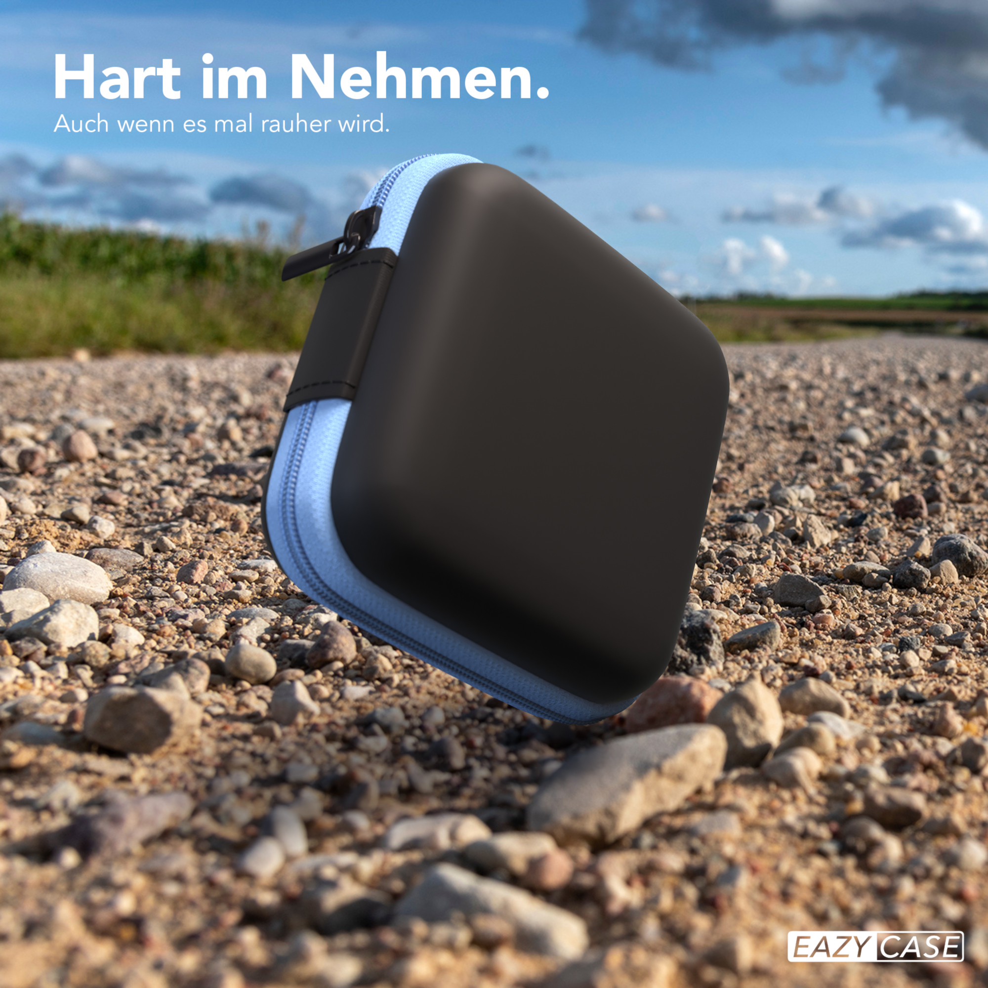 Schwarz-blaues Etui auf Schotterstraße, mit blauem Reißverschluss.