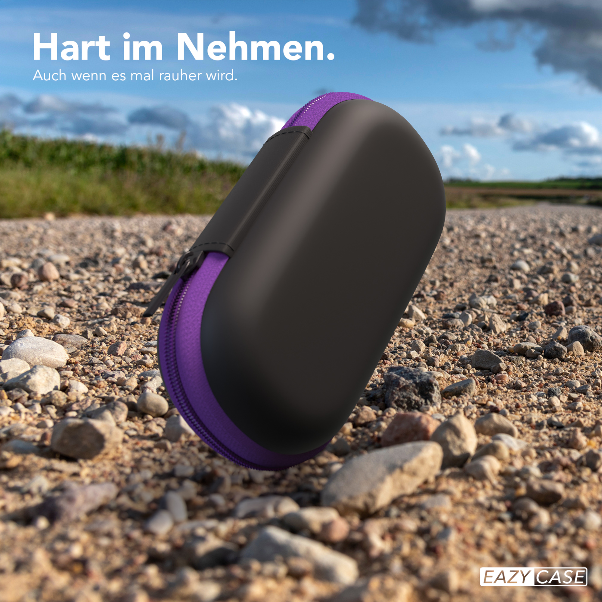 Schwarzes Etui mit lila Reißverschluss auf Schotterstraße.