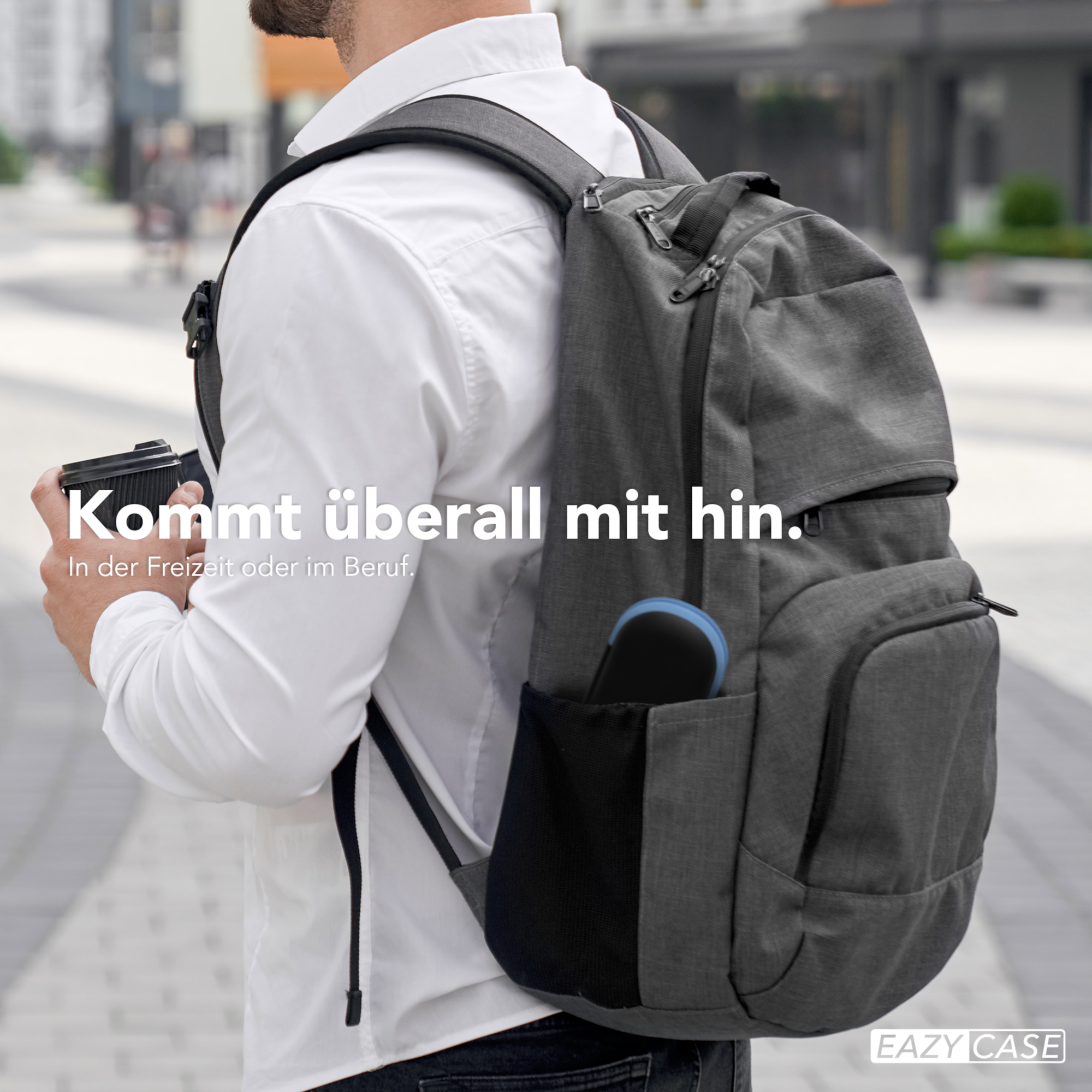 Mann mit Rucksack hält eine Kaffeetasse. Gebäudehintergrund, Text: Geht überall mit Ihnen hin.