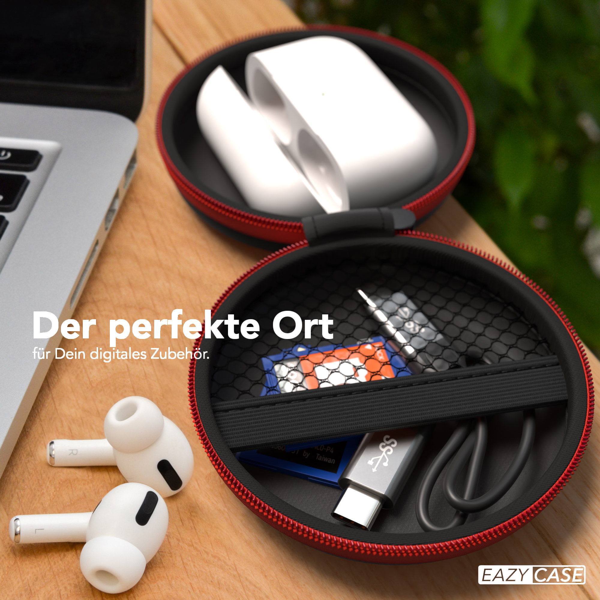 Weiße Ohrhörer in einem roten Etui neben einem Laptop auf einem Holztisch.