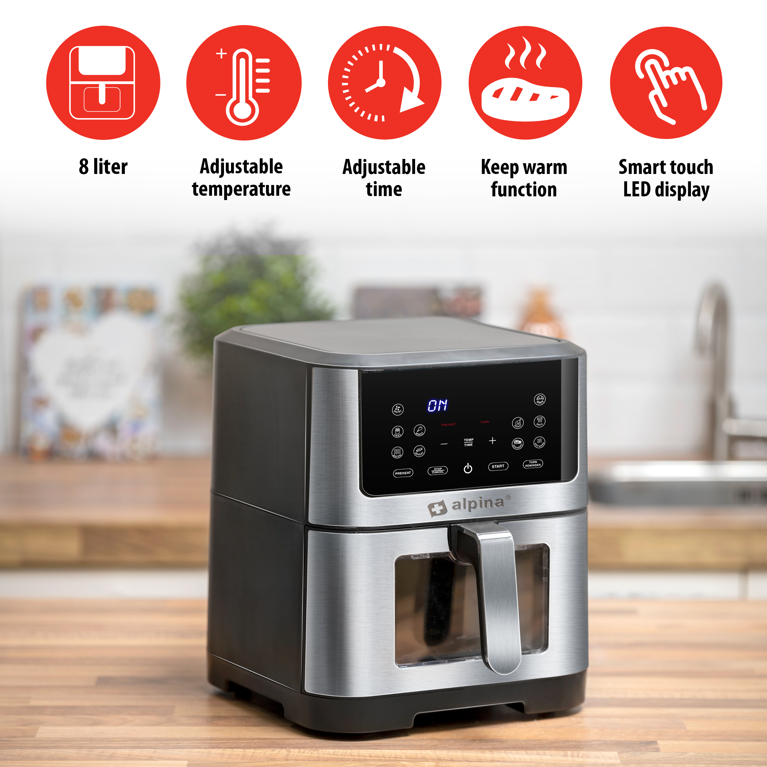 Silver and black air fryer with buttons and icons. A wooden countertop is the base.