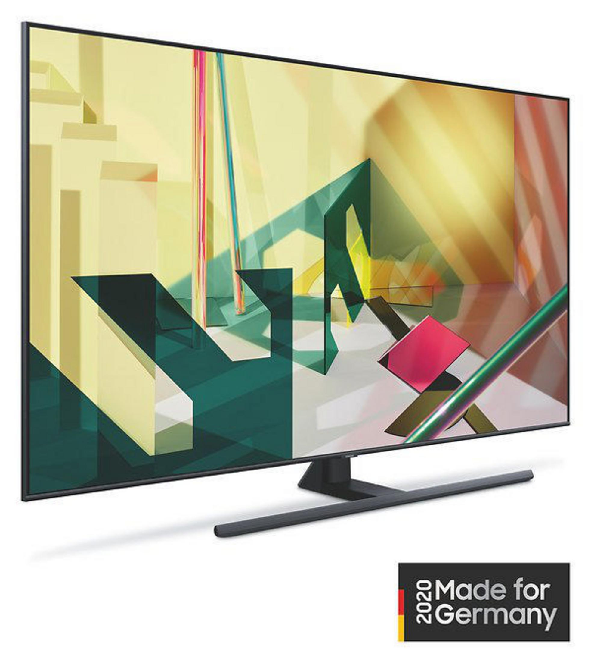 Duży telewizor pokazujący abstrakcyjny obraz na ekranie, z czarną ramą i stojakiem.