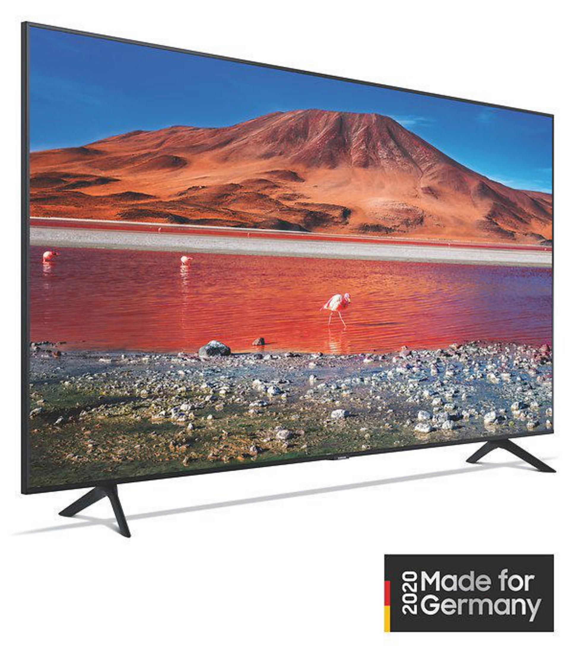 Nowoczesny telewizor wyświetla żywy krajobraz z czerwoną wodą i górami. Telewizor ma czarną ramę.