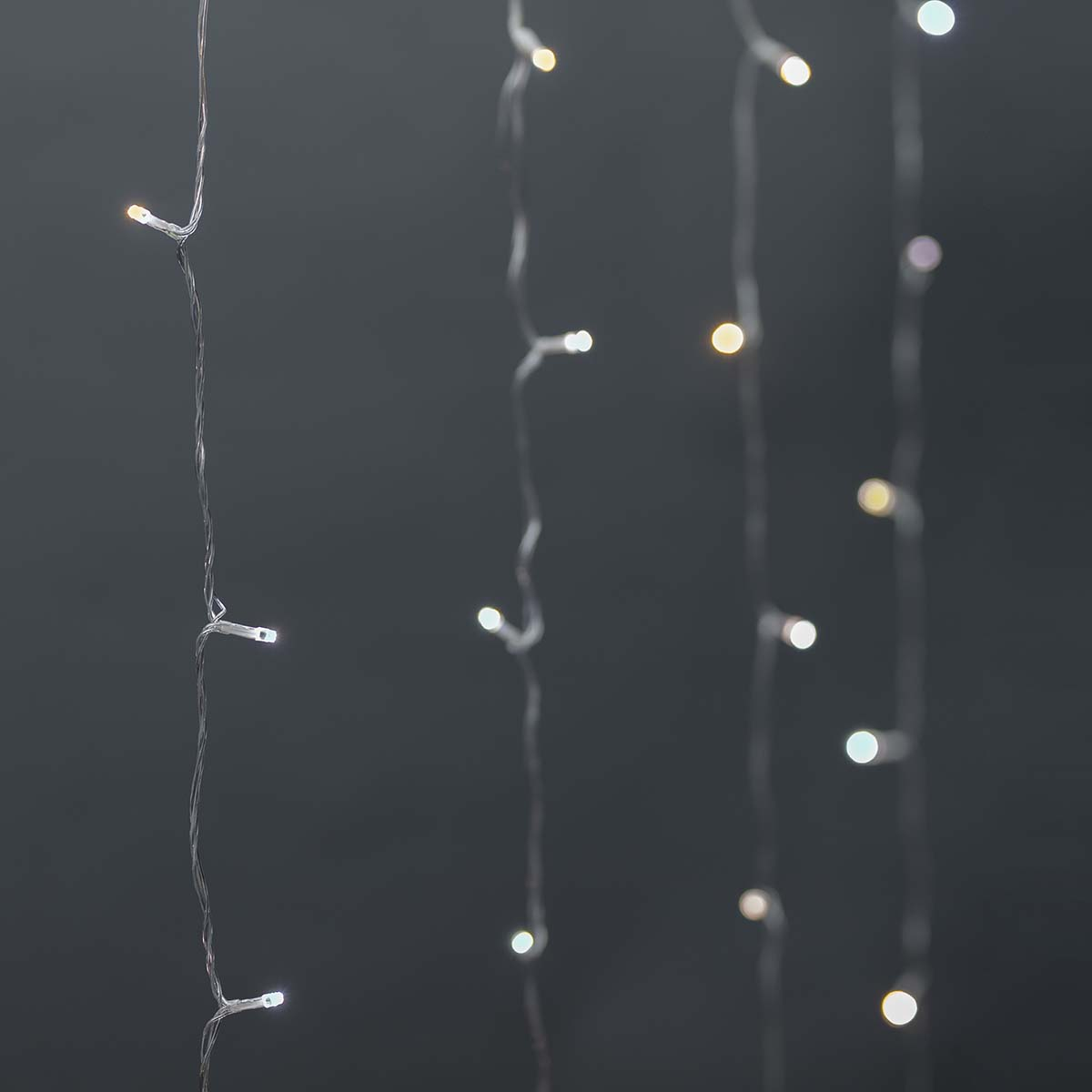 Several strands of small white lights hanging against a dark background.