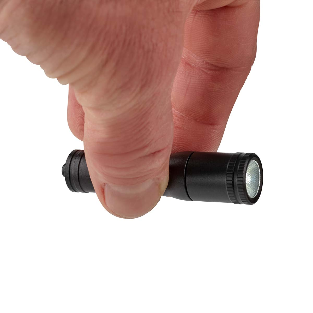 Una mano sosteniendo una pequeña linterna negra. La luz está encendida.