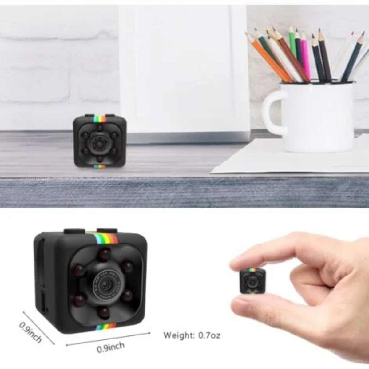 Eine kleine schwarze Kamera mit Regenbogenstreifen, gehalten von einer Hand. Weißer Hintergrund.