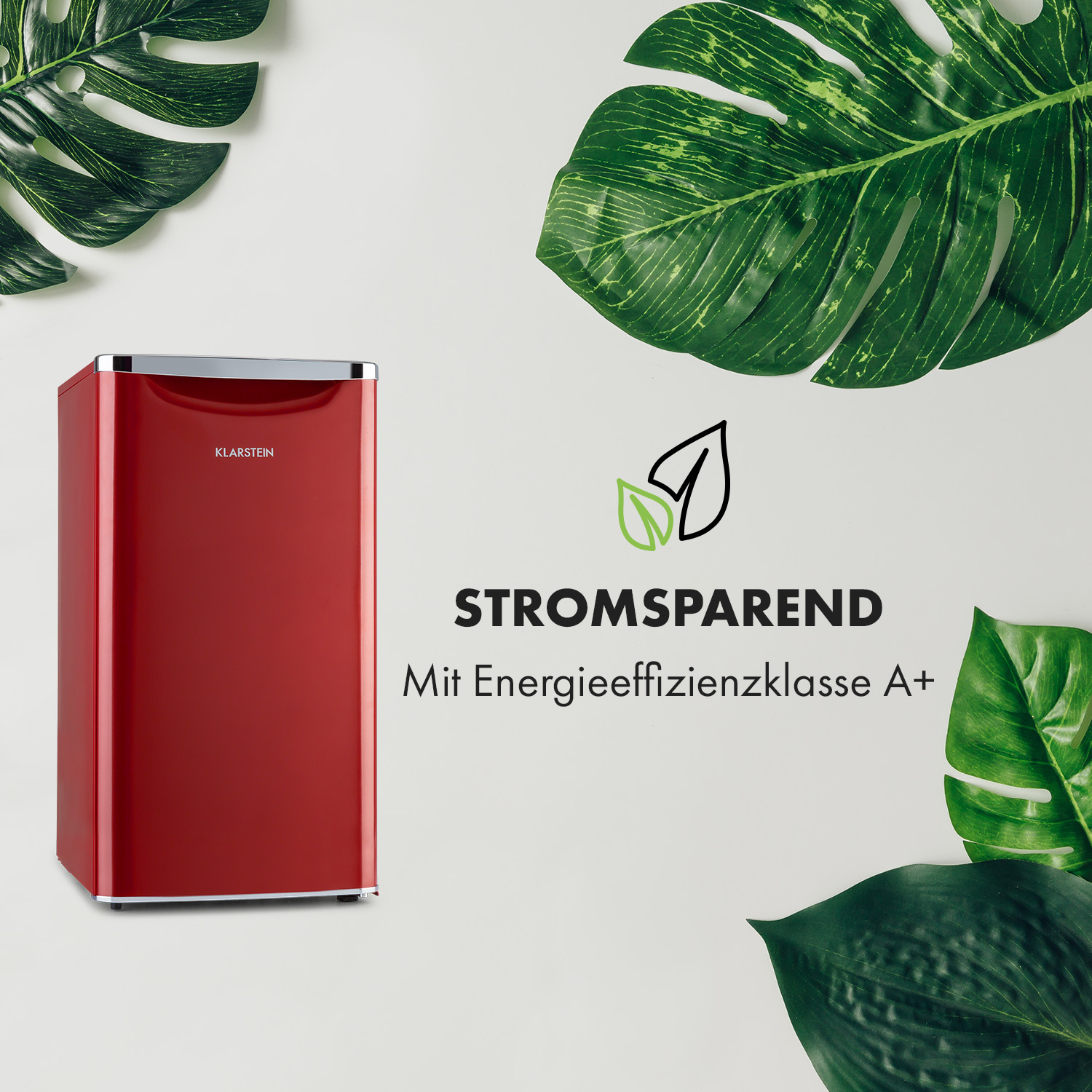 Ein roter Mini-Kühlschrank mit weißem Hintergrund und grünen Blättern. Text: Stromsparend.