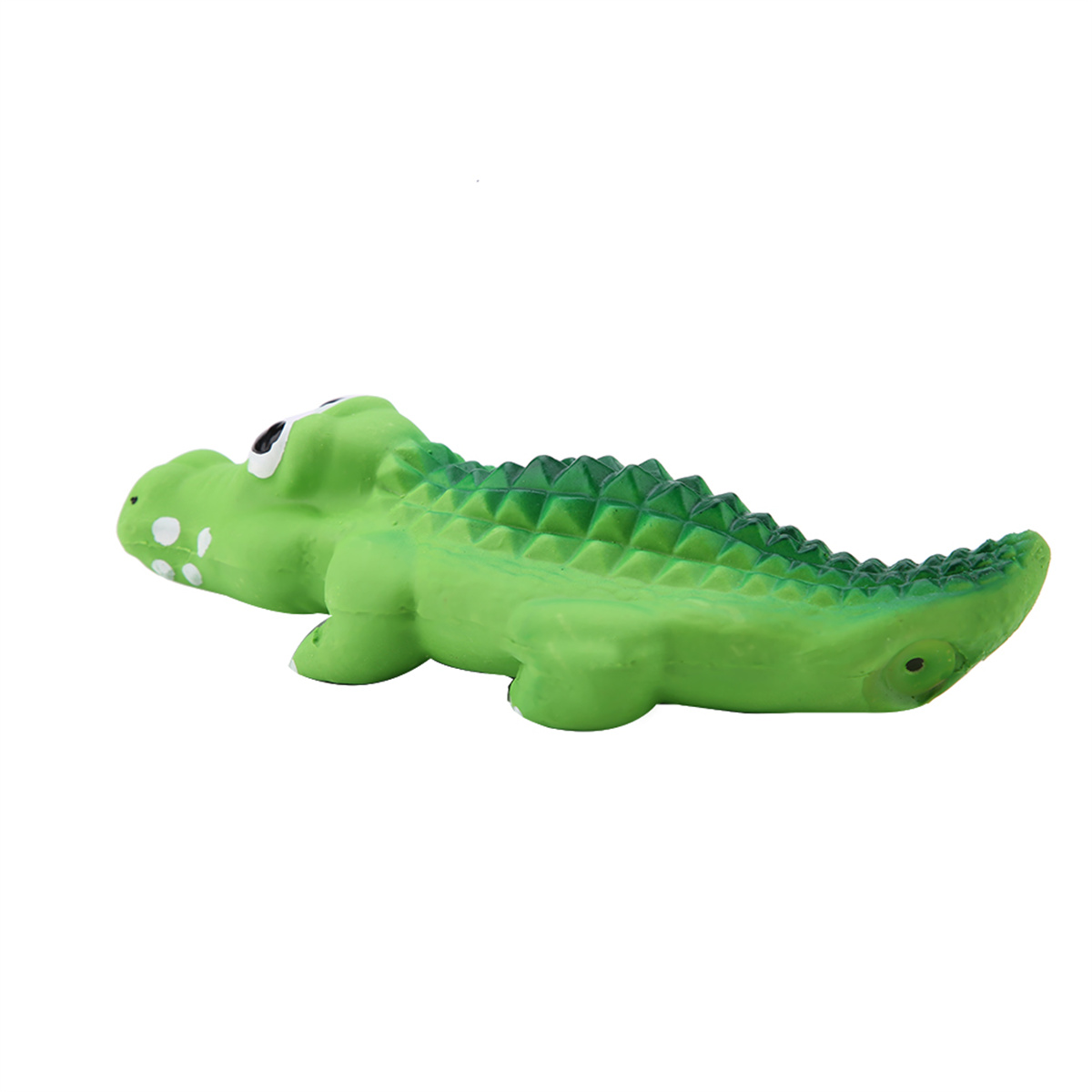 Grünes Spielzeug-Alligator auf weißem Hintergrund. Das Spielzeug liegt flach.