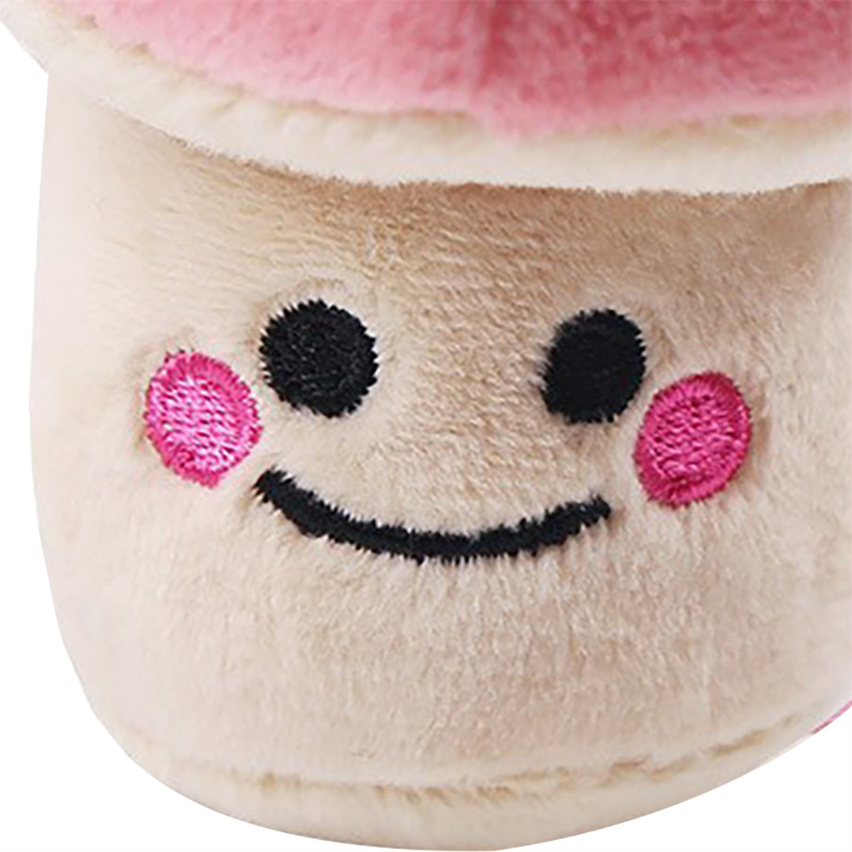 Nahaufnahme eines Plüschpilzspielzeugs zeigt ein lächelndes Gesicht mit rosa Wangen.