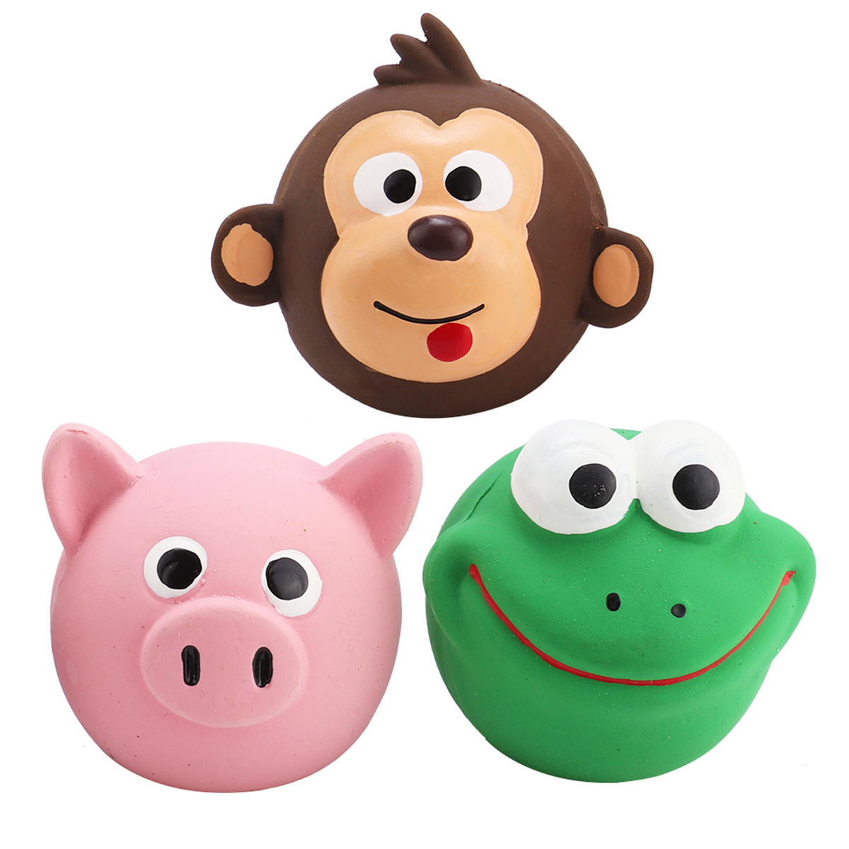 Drei Gummispielzeuge. Affe, Schwein und Frosch. Der Affe ist braun, das Schwein rosa und der Frosch grün.
