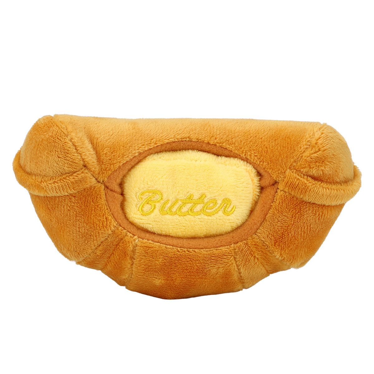 Ein plüschiges, butterförmiges Spielzeug, hellbraune Außenhaut mit gelber Mitte und Text 'Butter'.