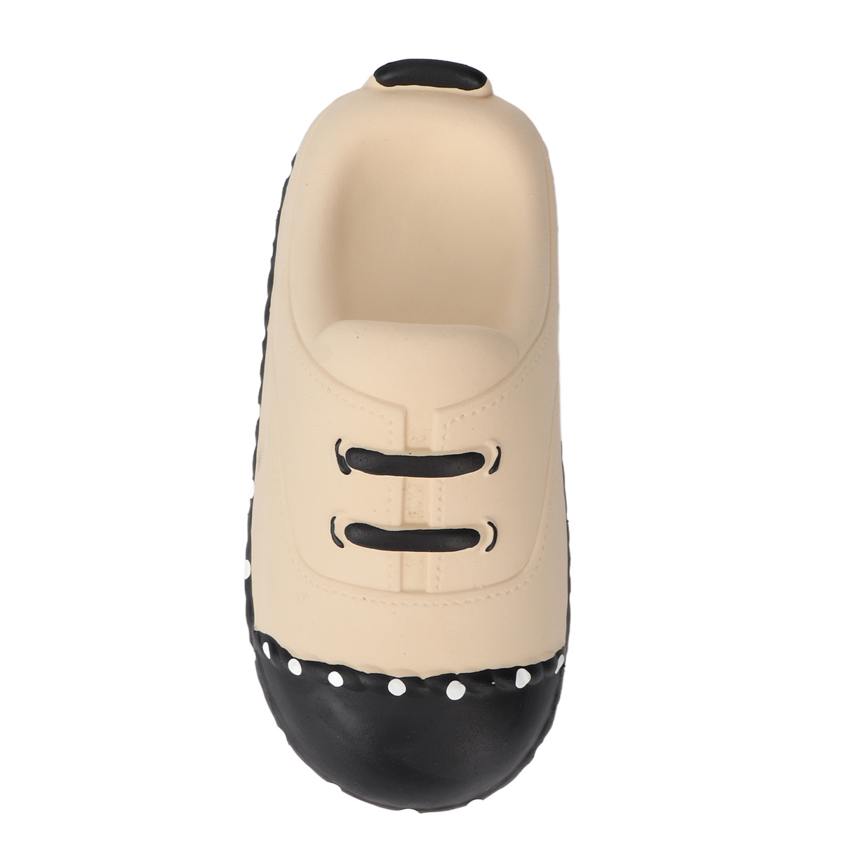 Beiger Schuh mit schwarzen Schnürsenkeln und schwarzer Sohle mit weißen Punkten.