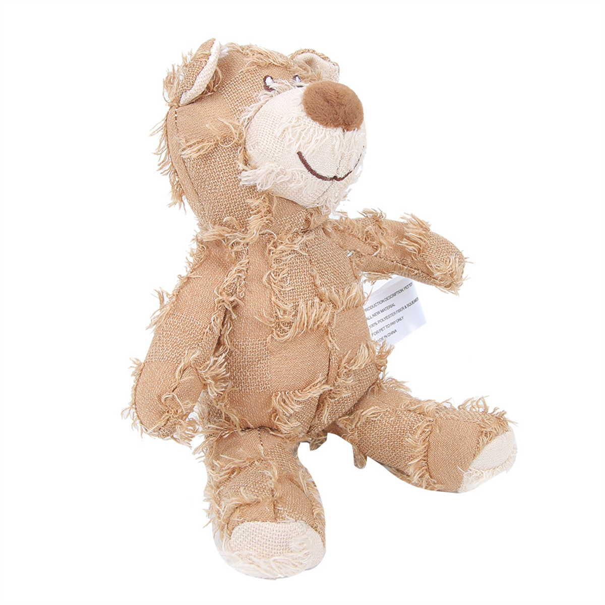 Braunes Teddybär-Spielzeug mit abgenutzten Nähten und einem Etikett.