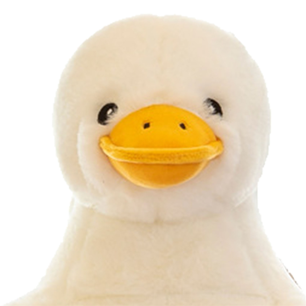 Nahaufnahme einer weißen Plüschente mit gelbem Schnabel. Die Ente hat ein lächelndes Gesicht.