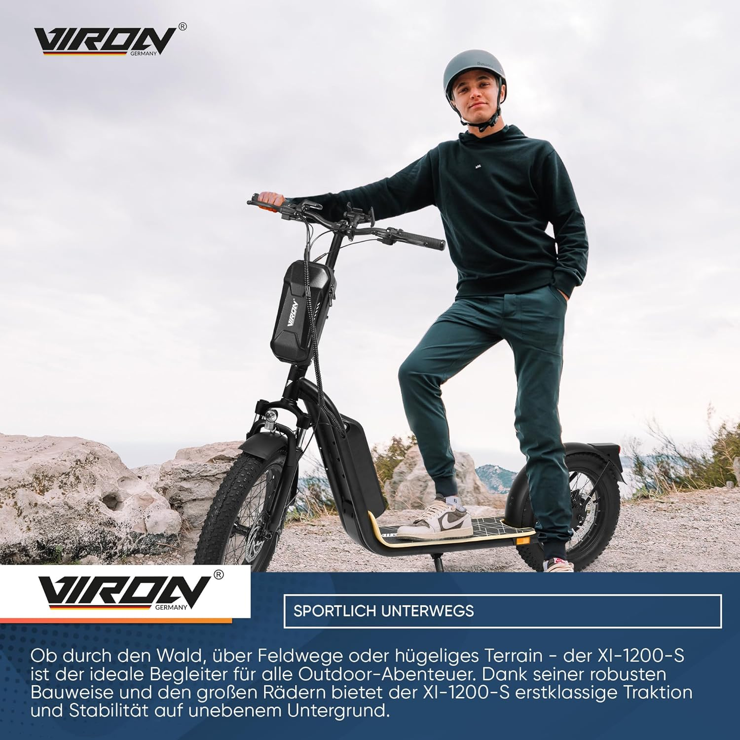Mann fährt mit einem Elektroroller auf einem felsigen Weg. Der Roller hat ein schwarz-gelbes Design.