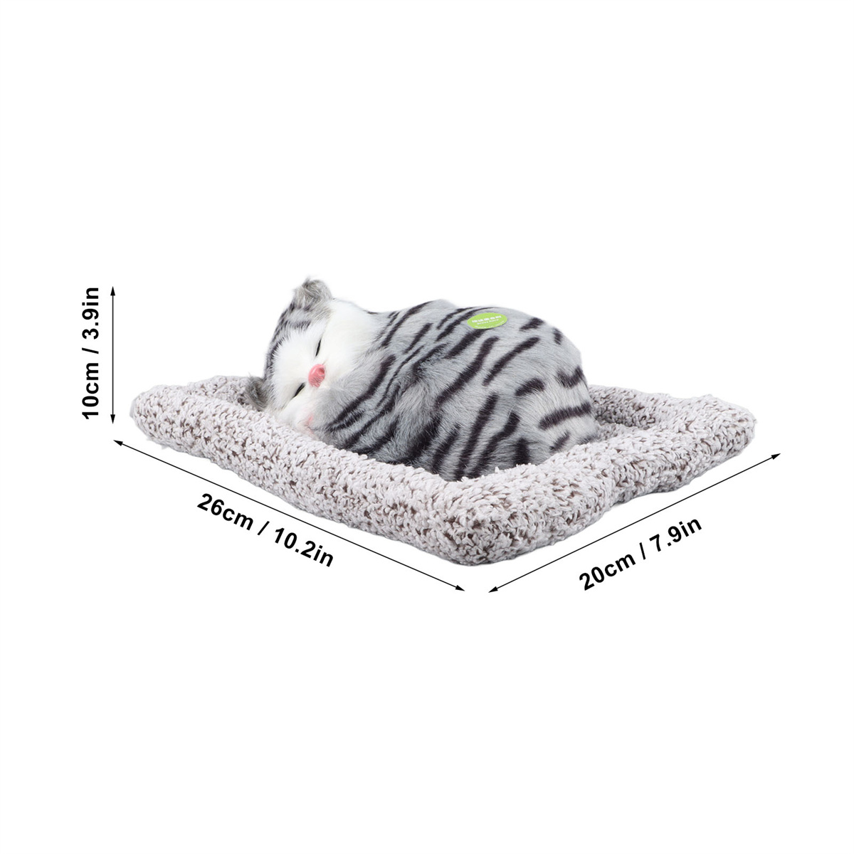 Ein schlafendes grau-weißes Katzenspielzeug auf einem grauen Bett, mit den angegebenen Abmessungen: 26 cm x 20 cm x 10 cm.