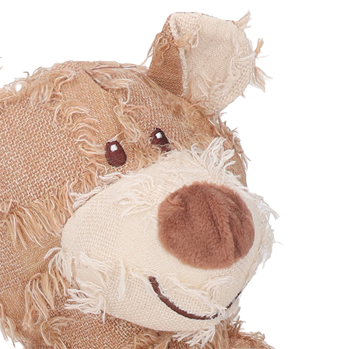 Nahaufnahme des Gesichts eines Teddybären. Er hat eine braune Nase und ein aufgenähtes Lächeln.