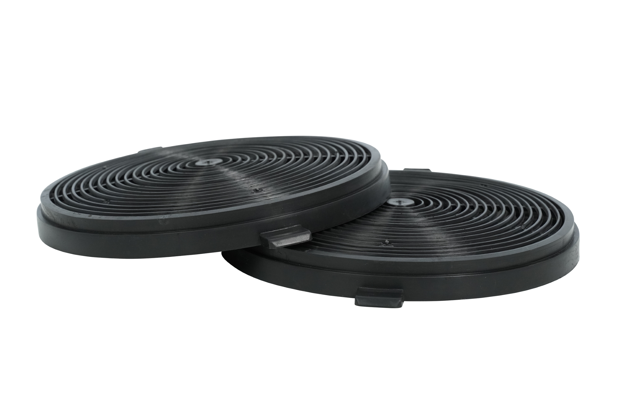 Two black charcoal filters, circular with concentric grooves, isolated on a white background.