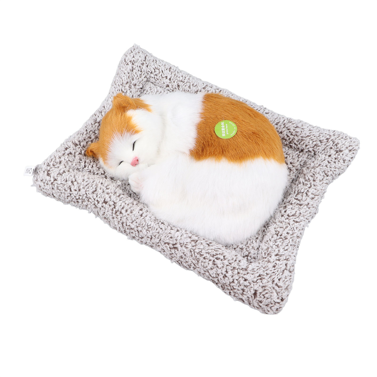 Eine schlafende Katze auf einem grauen Haustierbett. Die Katze ist orange und weiß.