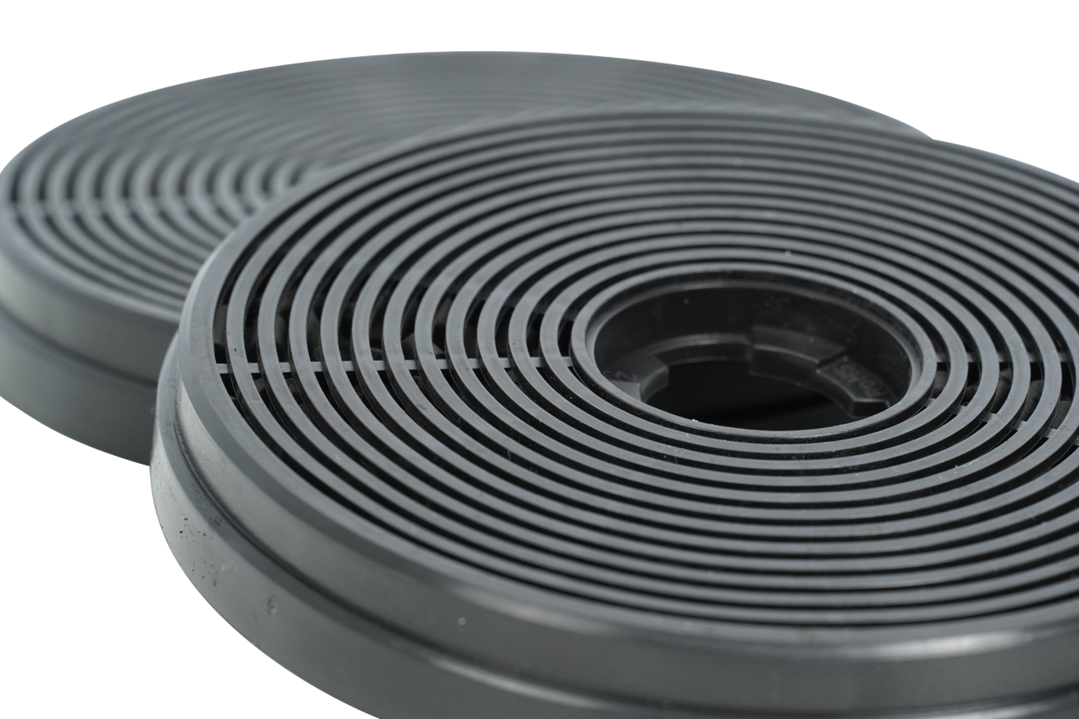 Two dark grey, circular charcoal filters. White background.
