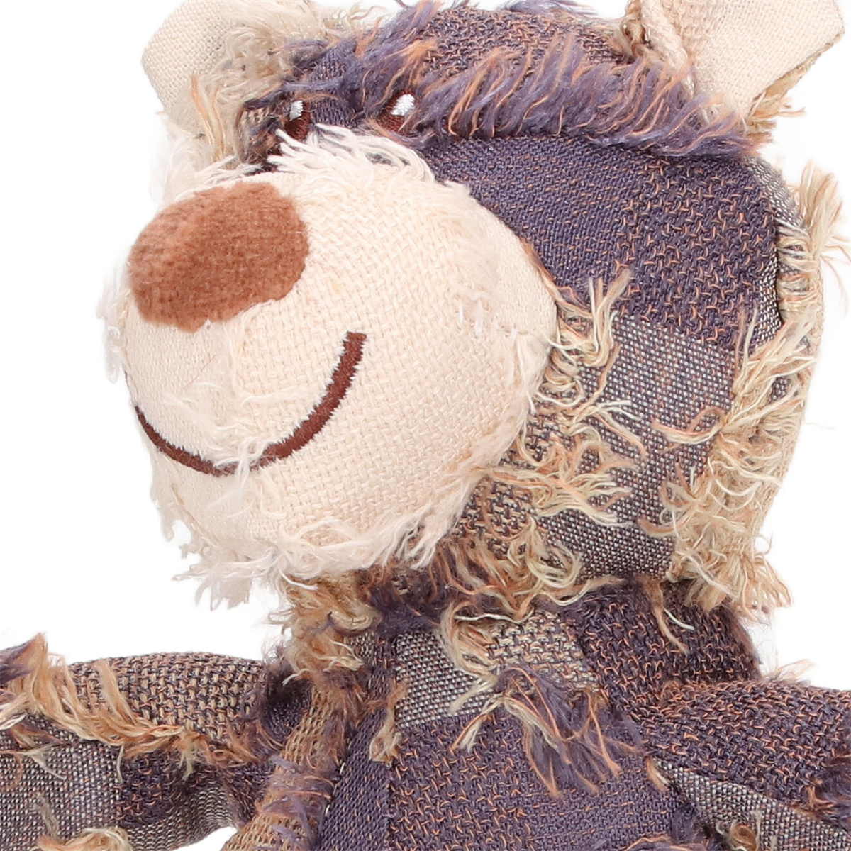 Teddybär-Spielzeug mit Patchwork-Design, Nahaufnahme des Gesichts, das ein Lächeln zeigt.