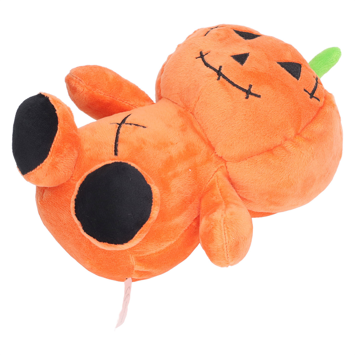 Orangenes kürbisförmiges Plüschtier. Es hat einen grünen Stiel, schwarze Augen und liegt auf dem Rücken.