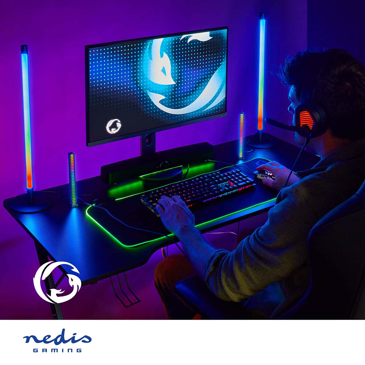 Gamer using computer with RGB lights. Purple and black background.