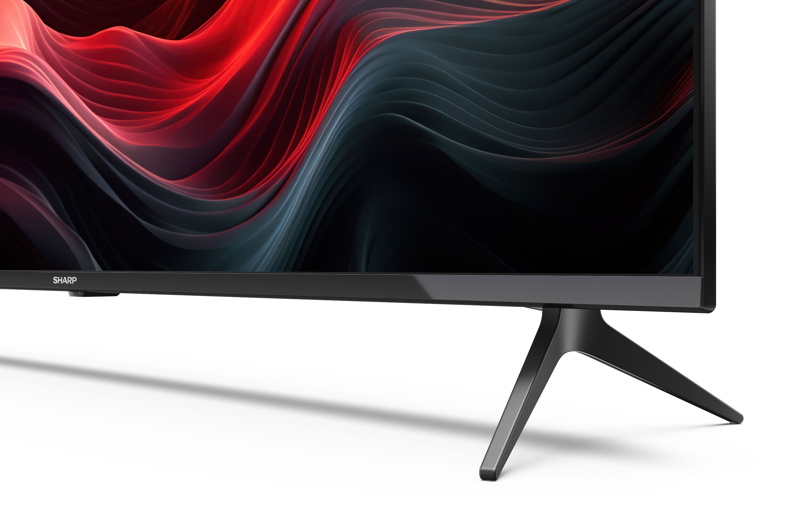 Uno schermo TV nero con un design ondulato rosso e nero. La TV è su un supporto nero.