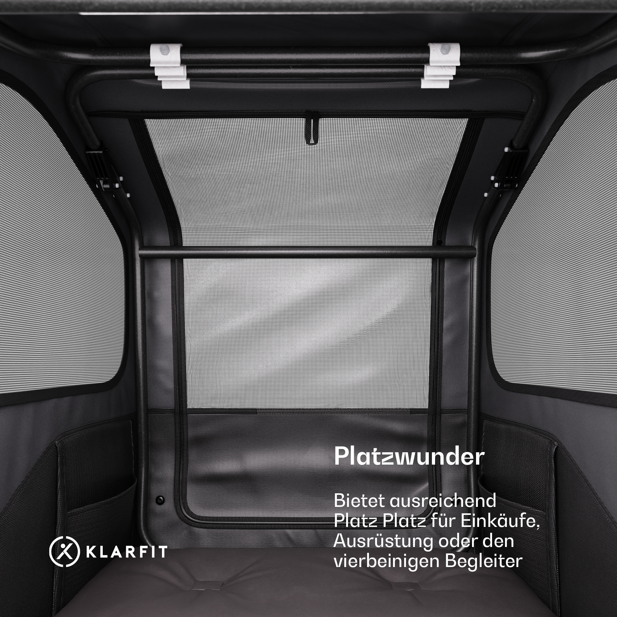 Schwarzer Haustieranhänger-Innenraum. Text: Platzwunder, bietet Platz für Einkäufe, Ausrüstung oder Haustiere.