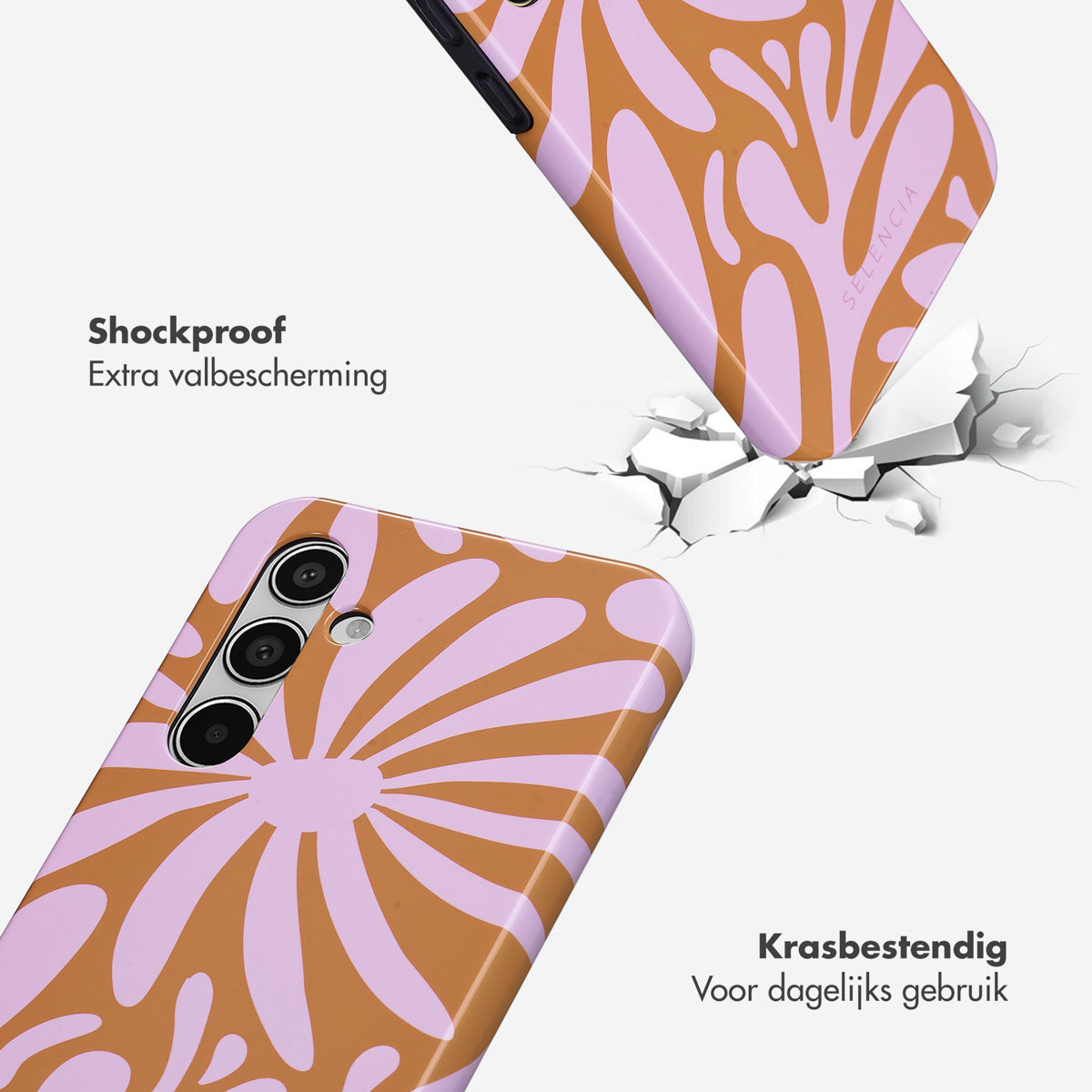 Paarse en bruine telefoonhoes met bloemenpatroon, op gebarsten grond.