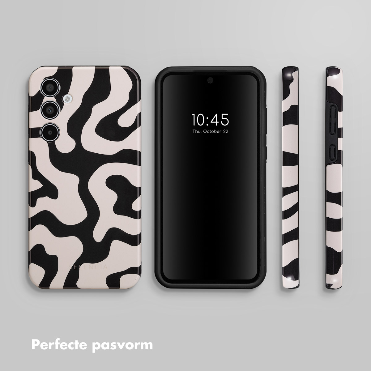 Un téléphone avec une coque à motif de taches noires et blanches et un écran noir.