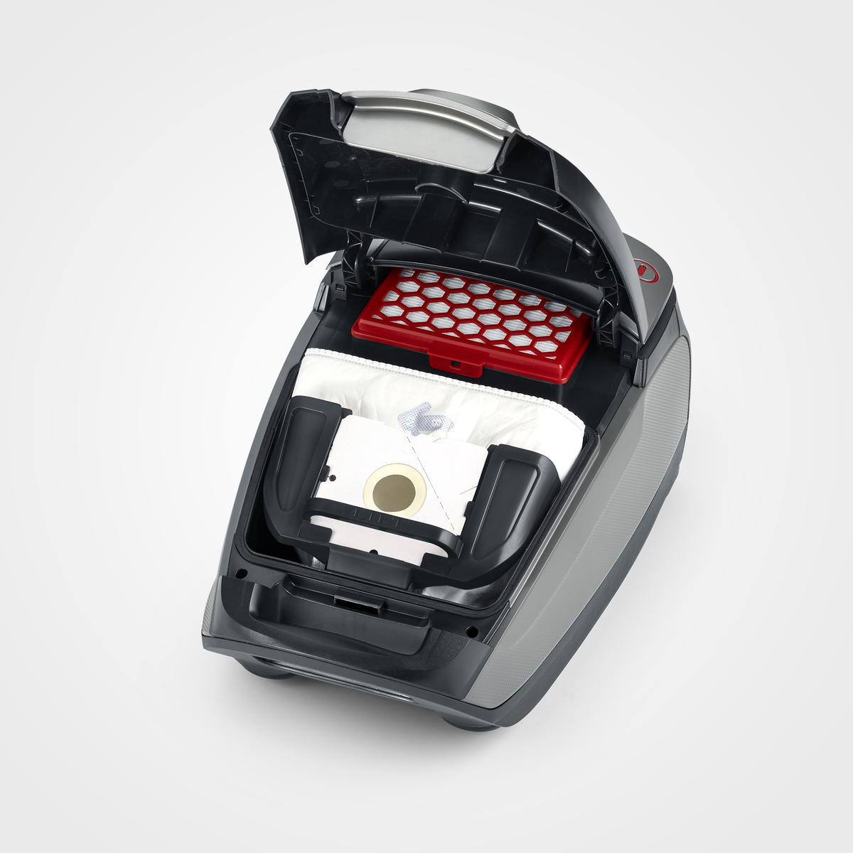 Czarny odkurzacz z otwartą górą, odsłaniający czerwony filtr i biały worek na kurz. Nowoczesny design.