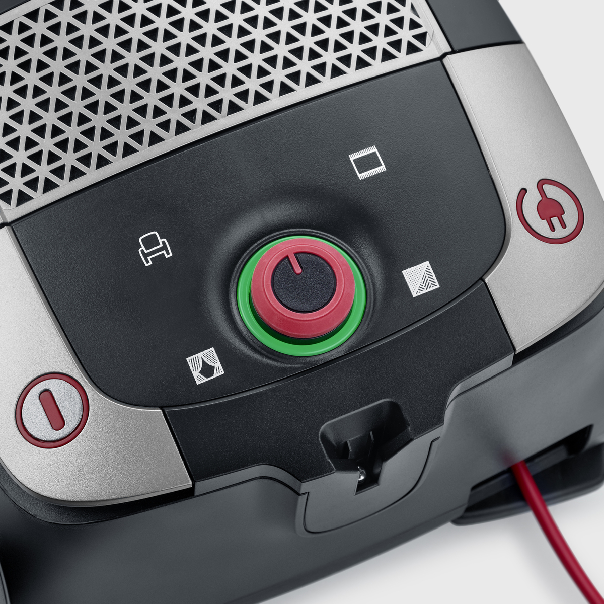 Odkurzacz z panelem sterowania. Widoczny jest czerwony przycisk zasilania i pokrętło.