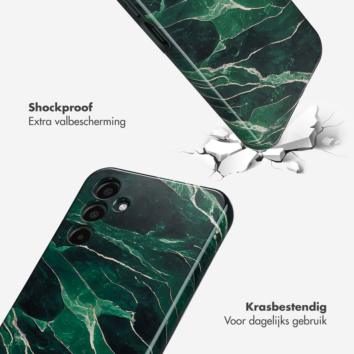 Twee groene marmeren telefoonhoesjes, één valt op gebarsten grond.