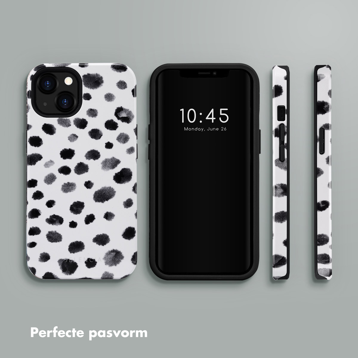 Coque de téléphone avec des pois noirs et blancs à côté d'un téléphone affichant l'heure et la date.