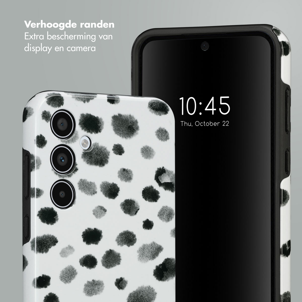 Custodia per telefono con pois bianchi e neri. Un telefono nero con bordo nero è a destra.