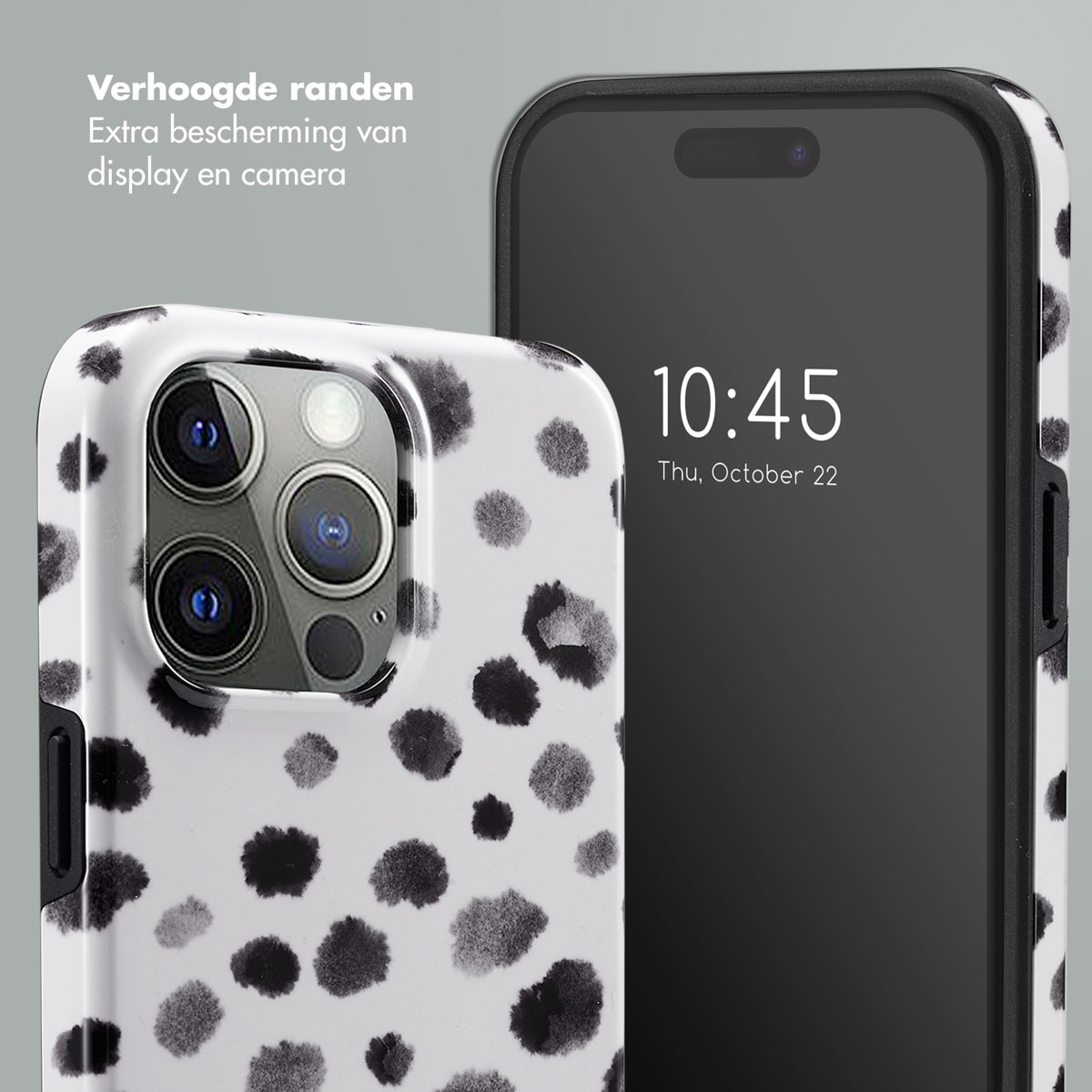 Gros plan d'une coque de téléphone à pois noirs et blancs et d'un téléphone affichant l'heure 10:45.